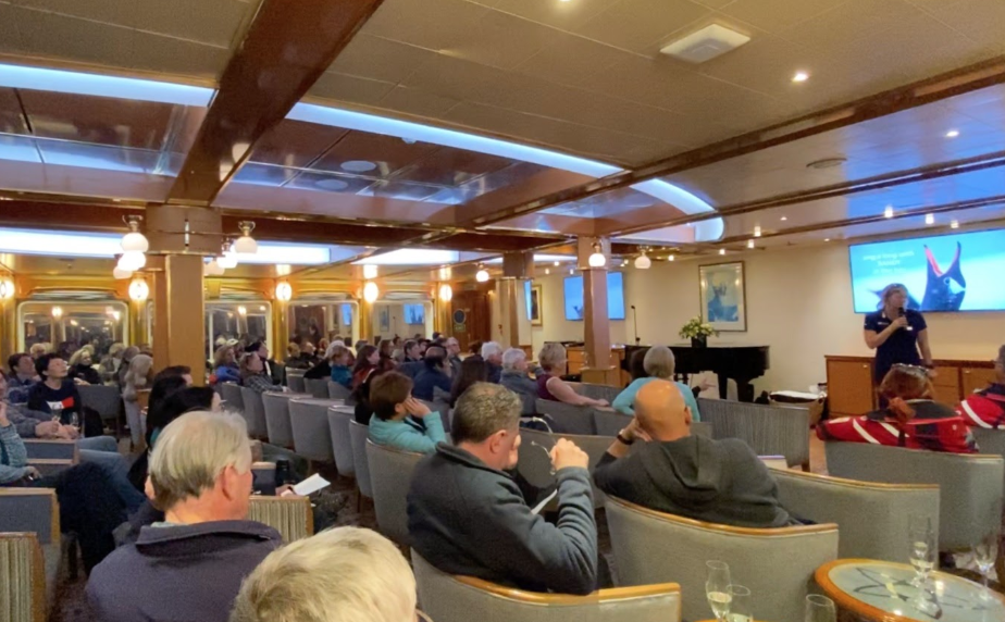 An onboard lecture being given by an Antarctic expedition leader on an Antarctic cruise ship